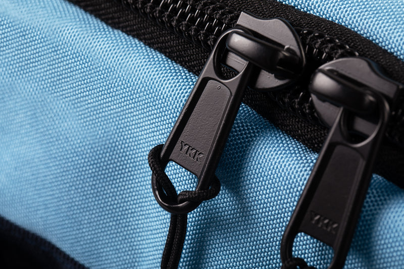 YKK zippers on blue travel bag